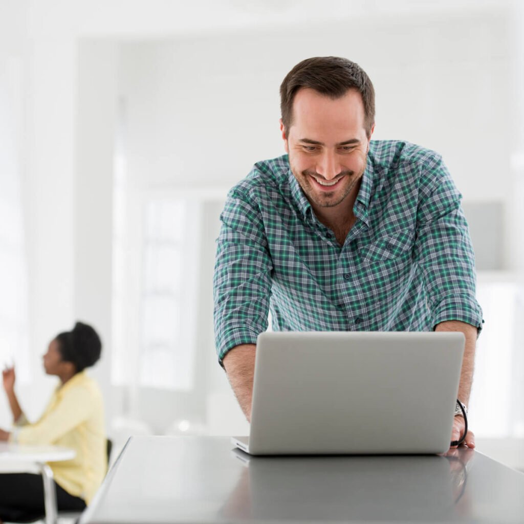 How React is Transforming The Web and Mobile Development a man seated at a table using a laptop computer 2025 04 04 08 31 53 utc